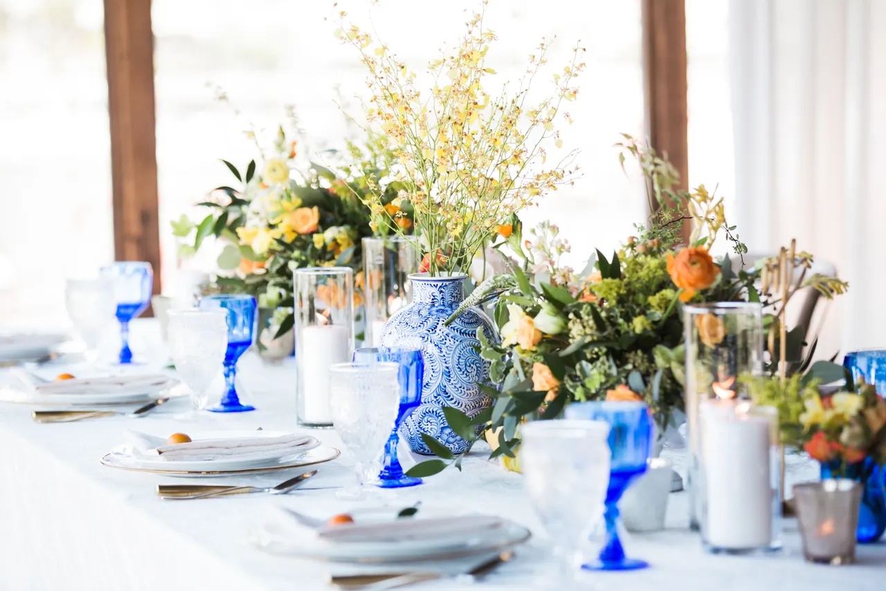 Tablescape detail — blue-and-white ceramics, citrus, and candlelight.